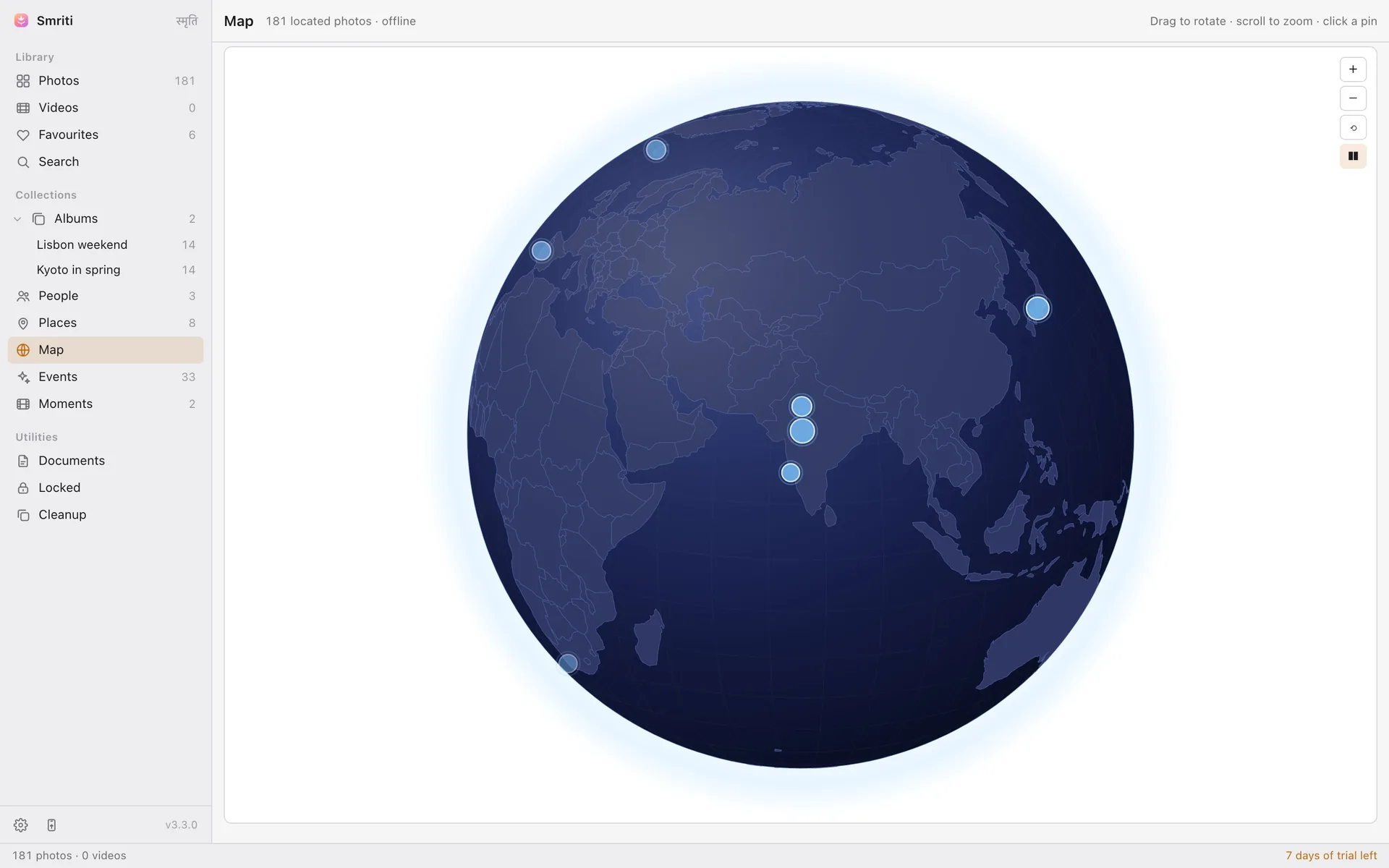 Smriti's offline globe showing pinned photo locations across continents, with no map tiles fetched from anywhere.